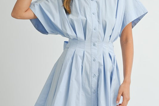 Discover versatile style with the Melissa Dress. This solid poplin mini dress features a front pleated button-down collared shirt design, complete with a self-tie waist detail that can be worn in the front or back. With a baby blue color, this dress is great for day or night.