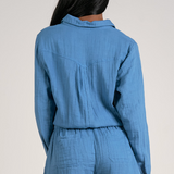 Expertly crafted from a soft blue gauze fabric, this long sleeve romper offers comfort and style. The snap button closure adds convenience and ease to your daily routine. Perfect for any occasion, this romper is a must-have addition to your wardrobe.