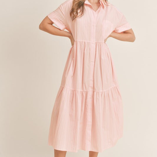 Upgrade your wardrobe with the Mable Midi Dress. This loose-fitting, short-sleeved dress boasts a stylish tiered stripe design and collared neckline. Its midi length and button-down closure provide a comfortable and chic look. Perfect for any occasion, elevate your style with this must-have piece.