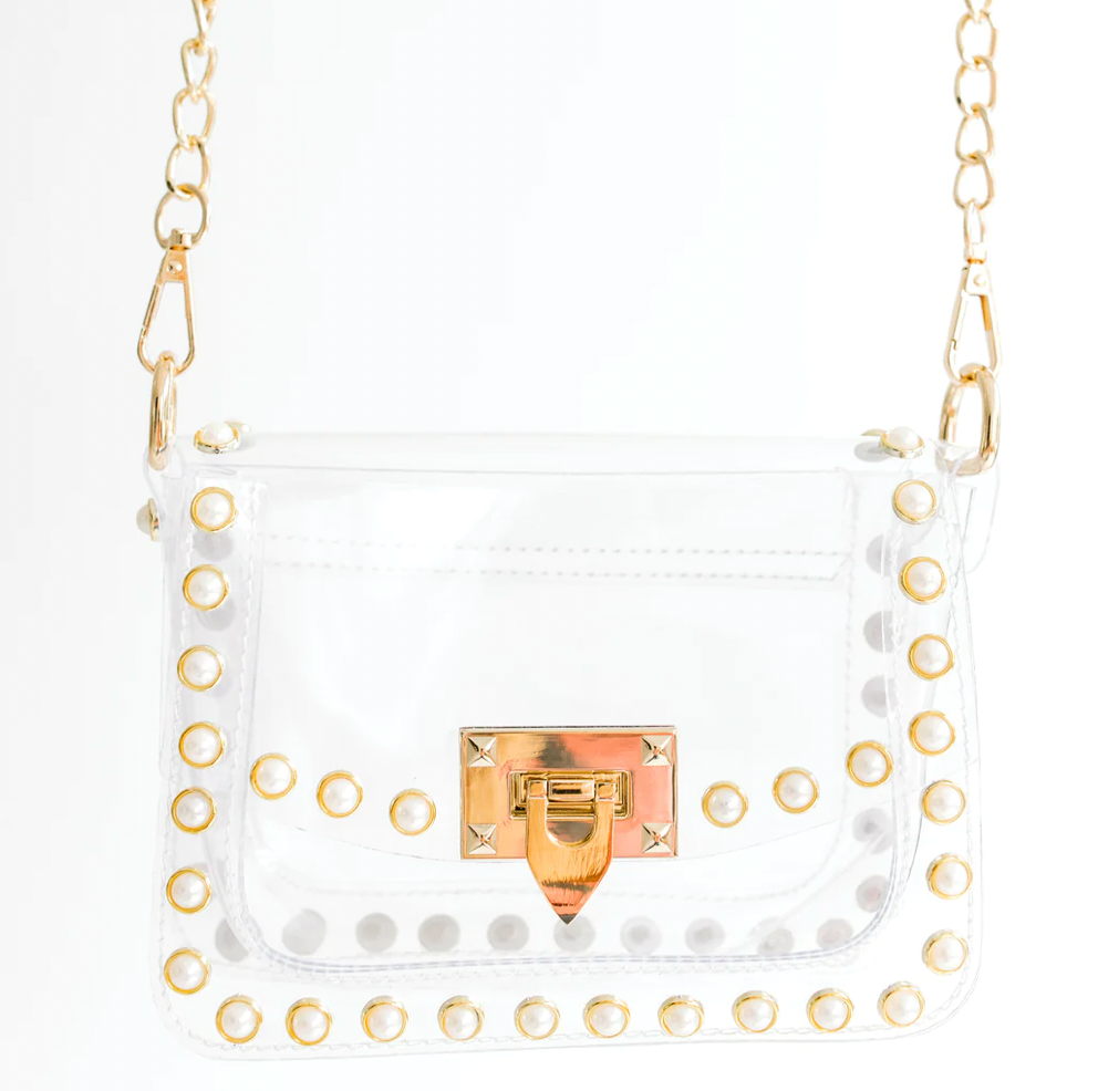 Score with the biggest winner in our clear handbag playbook - The Jackie! The Jackie changed the handbag game by proving clear handbags could be both functional and chic. This style includes pearl metal studs and a gold chain. The Jackie is NCAA and NFL compliant and the ideal size to hold your wallet, phone, keys, lip gloss and a few other small items.