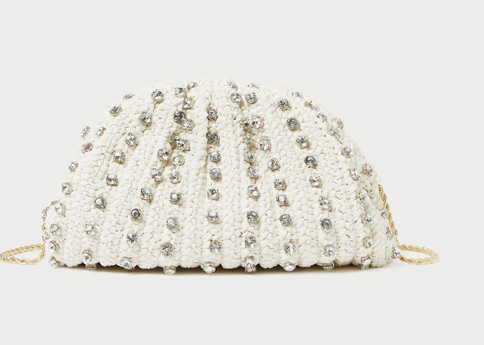 Dome-shaped frame pouch in natural crocheted raffia with rhinestone embellishment. Features a removable twisted gold metal shoulder strap, frame closure, full lining, and interior card slot