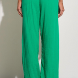 Upgrade your summer wardrobe with these bright green gauze pants. Designed with an elastic waist, these pants are both comfortable and stylish. Perfect for a day at the beach, boat, or poolside. Pair with a white tank and your favorite flip flops for the ultimate summer vibe.